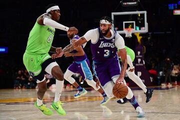 Nov 12, 2021; Los Angeles, California, USA; Los Angeles Lakers forward Anthony Davis (3) moves the ball against Minnesota Timberwolves forward Jarred Vanderbilt (8) during the second half at Staples Center. Mandatory Credit: Gary A. Vasquez-USA TODAY Spor